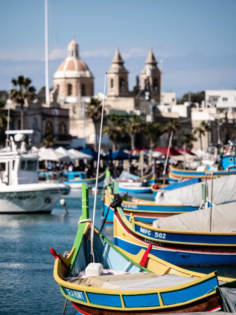Colorful fishing boats rest quietly in the harbor of Malta