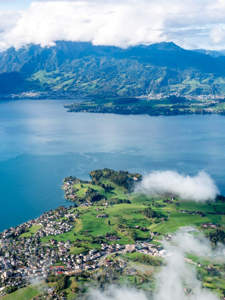 Soft clouds drifting above the blue waters of Lake Lucerne and the slopes of Rigi Kaltbad in central Switzerland