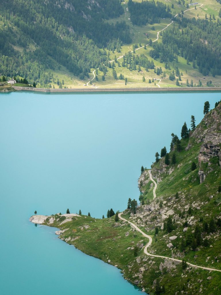 Above the turquoise stillness of Cleuson Lake, a narrow path winds along the mountain