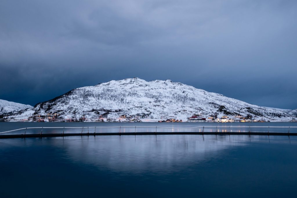 A breakwater in the calm bay of Kvaløyvågvågen, Norway