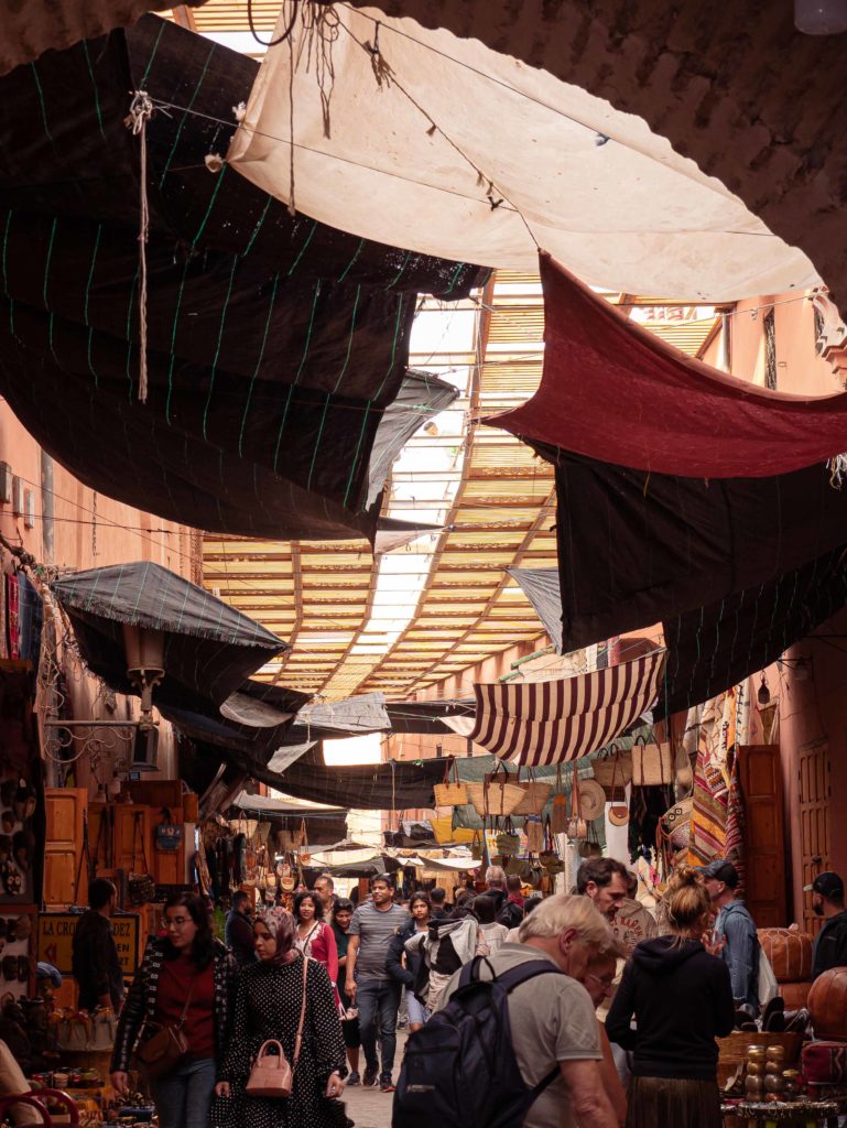 Crowded alleyway under the arches of a Moroccan souk
