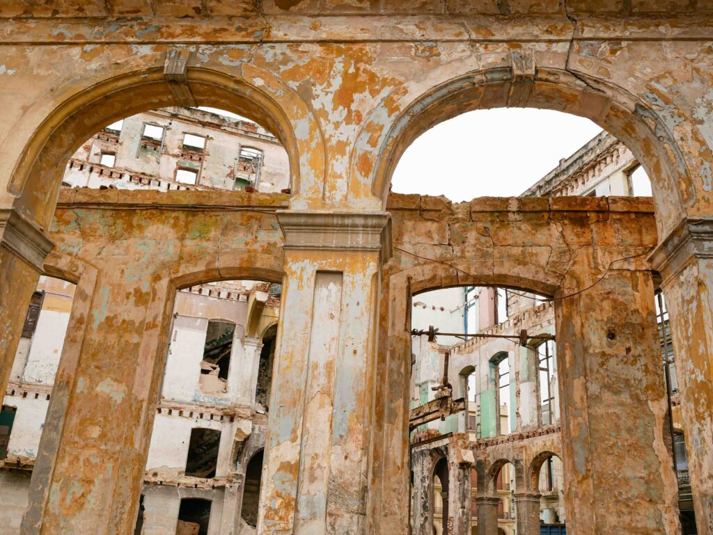 Ruined colonial theater with ornate arches in Old Havana