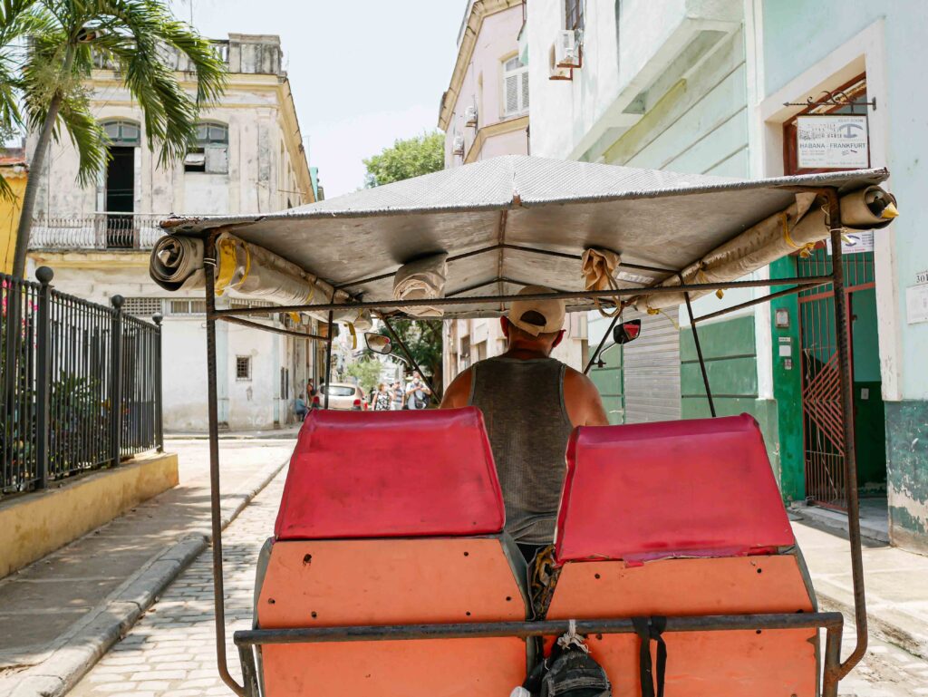 Traditional bicycle taxi parked on a quiet street in Old Havana